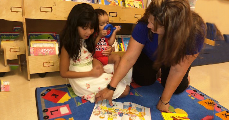 Girl in preschool with teacher