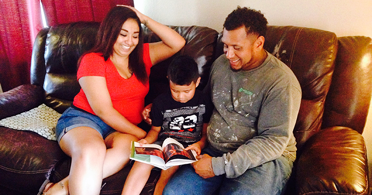 Mom and dad reading with son