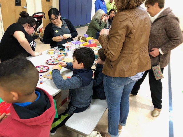 young boy coloring at table