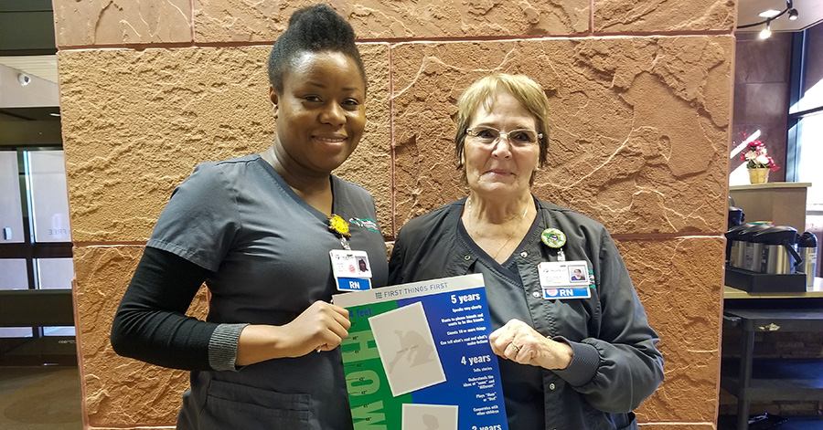 two nurses hold the FTF growth chart