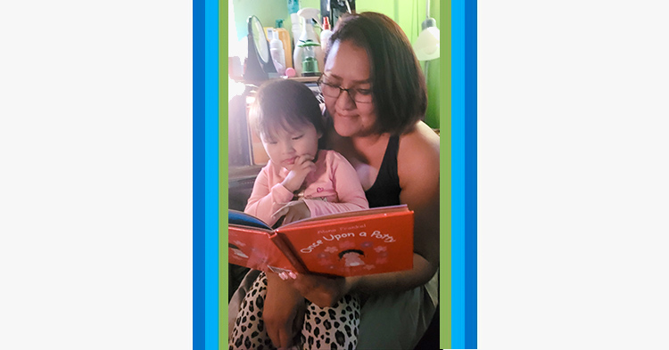 Mom reading a book to her toddler daughter