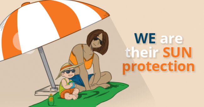 Mom and toddler sitting underneath a sun shade umbrella