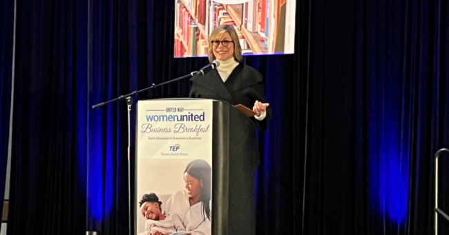 FTF CEO Melinda Morrison Gulick stands at a podium speaking at the United Way breakfast event.